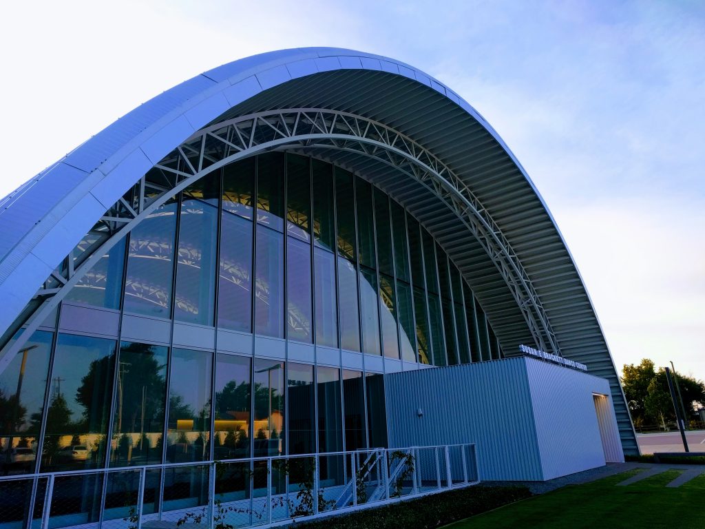 the outside of a dance center building with the facade as an oval shape